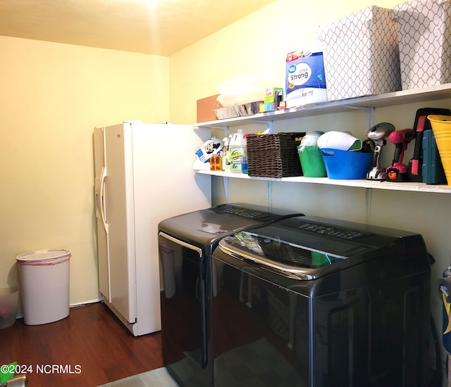 laundry room featuring dark hardwood / wood-style floors and washing machine and clothes dryer