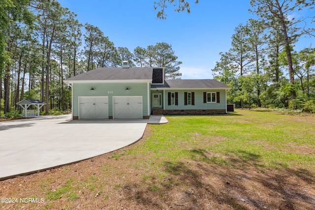 back of property featuring a garage, a shed, and a yard