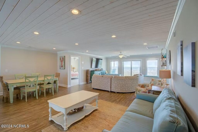 living room with ceiling fan, crown molding, and light wood-type flooring