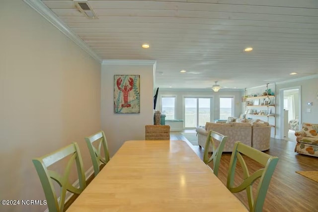 dining area featuring ceiling fan, ornamental molding, and hardwood / wood-style flooring