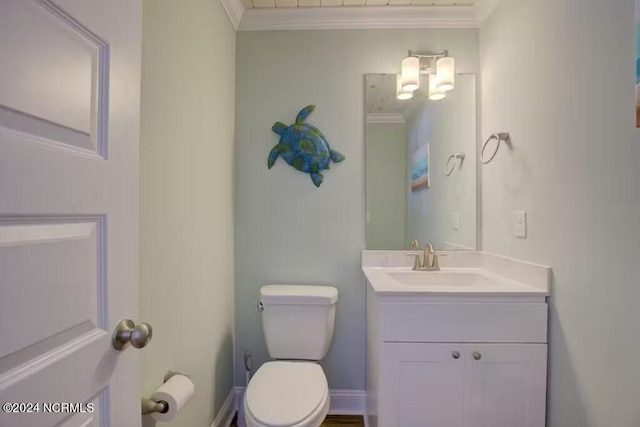 bathroom featuring ornamental molding, toilet, and vanity