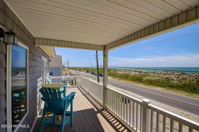 wooden terrace featuring a water view