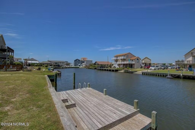 view of dock featuring a yard and a water view