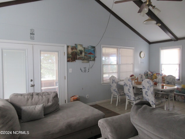 tiled living room featuring a wealth of natural light, vaulted ceiling with beams, ceiling fan, and french doors