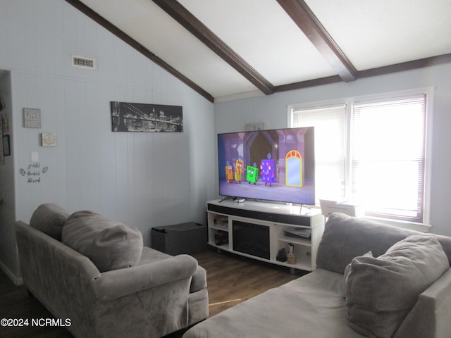 living room with plenty of natural light, vaulted ceiling with beams, and hardwood / wood-style flooring