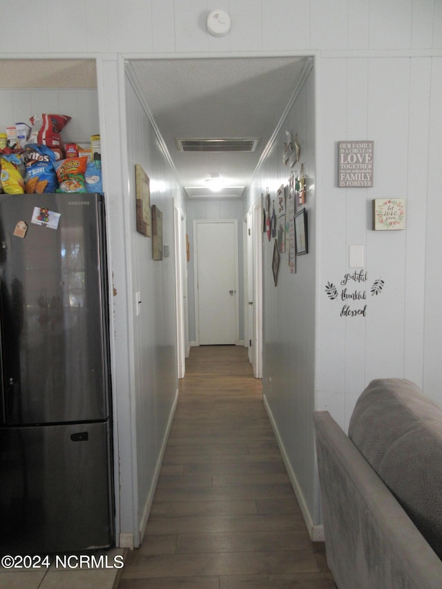 hallway with ornamental molding and dark hardwood / wood-style flooring