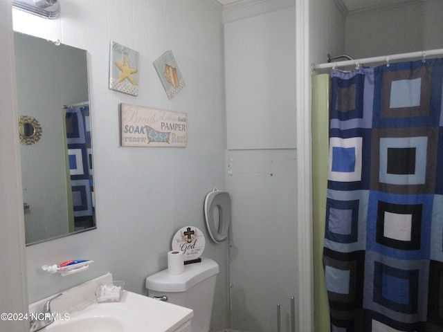 bathroom featuring crown molding, toilet, and vanity