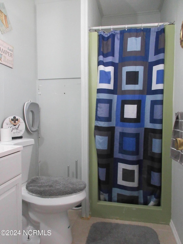 bathroom with tile flooring, vanity, and toilet