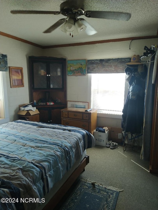 carpeted bedroom featuring a textured ceiling and ceiling fan