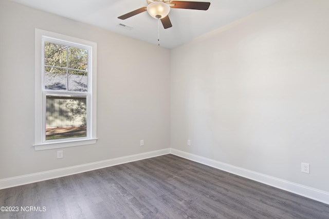 unfurnished room featuring dark wood-type flooring and ceiling fan