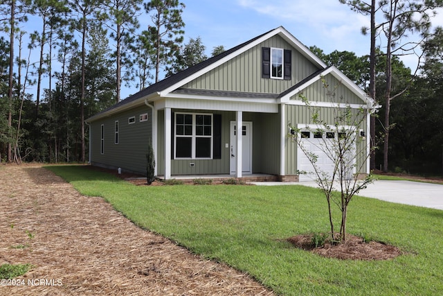 view of front of house with a garage, a front yard, and covered porch