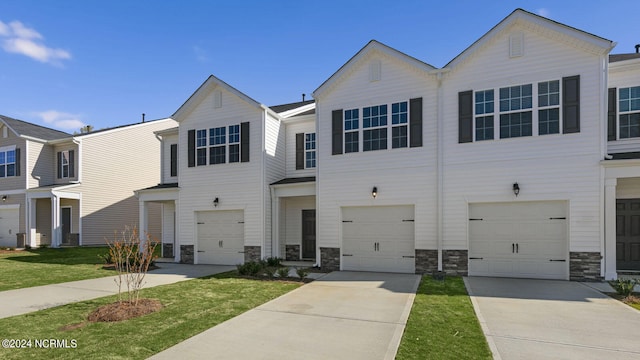 view of property with a front yard and a garage