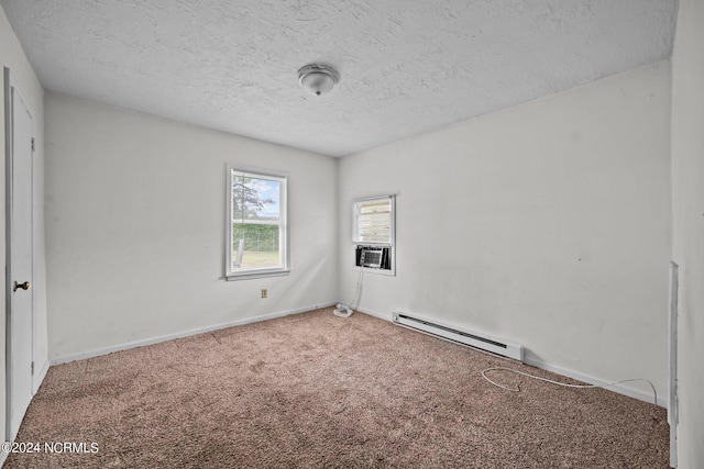 carpeted spare room featuring a baseboard heating unit, cooling unit, a textured ceiling, and baseboards