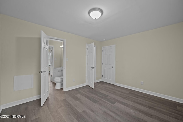 unfurnished bedroom featuring light wood-type flooring, ensuite bath, and baseboards