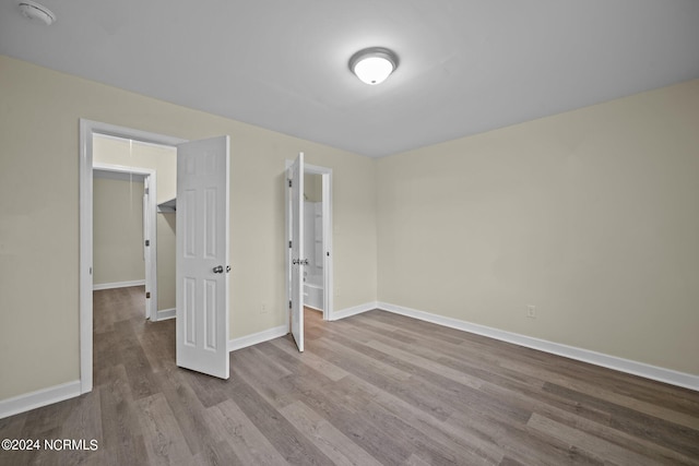 empty room with light wood-style flooring and baseboards