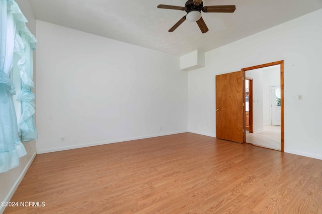 unfurnished room with ceiling fan and light wood-type flooring