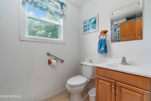 bathroom with tile floors, toilet, and vanity