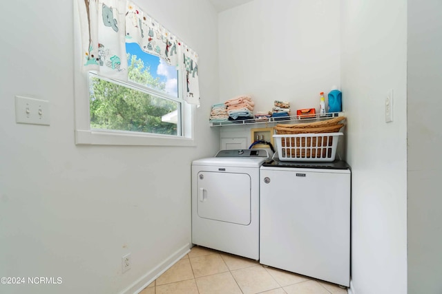 clothes washing area with washer hookup, light tile floors, and washing machine and dryer