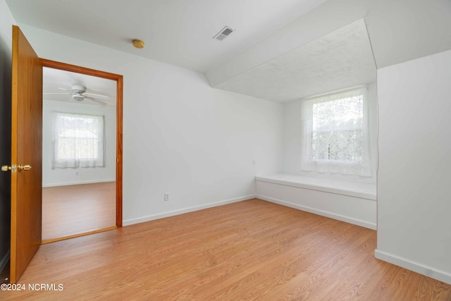 unfurnished room featuring a wealth of natural light, ceiling fan, and light wood-type flooring