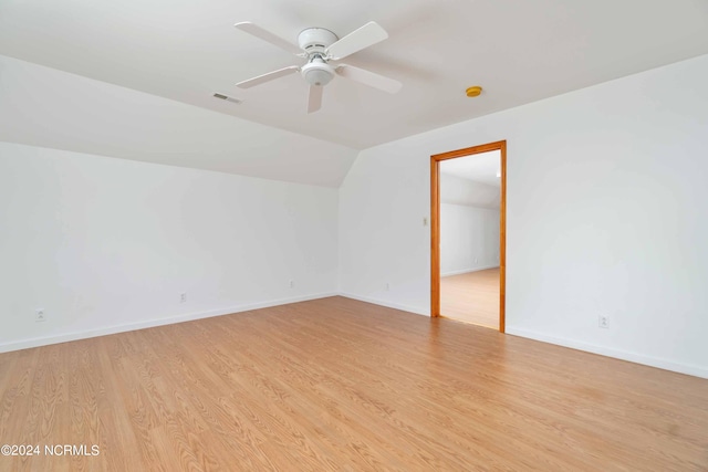 unfurnished room with light hardwood / wood-style floors, lofted ceiling, and ceiling fan