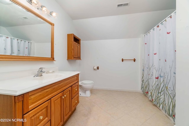 bathroom with vanity, toilet, and tile floors