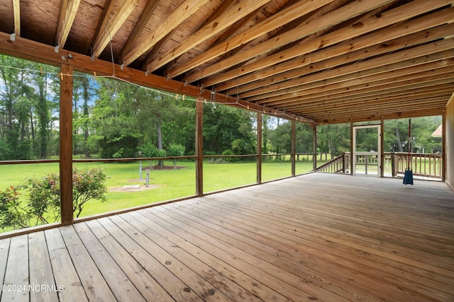 wooden terrace with a lawn