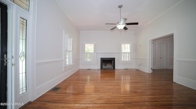 unfurnished living room featuring visible vents, a ceiling fan, wood finished floors, crown molding, and a fireplace