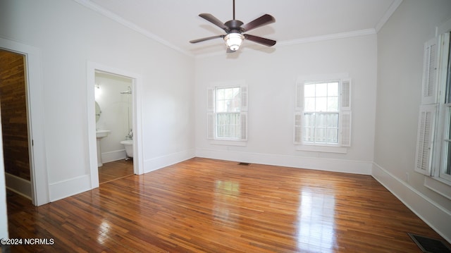 unfurnished bedroom featuring baseboards, visible vents, ornamental molding, and hardwood / wood-style floors