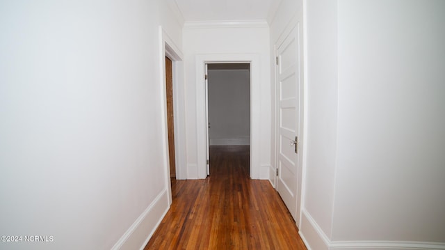 corridor featuring ornamental molding and wood finished floors