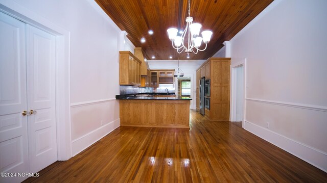 kitchen with dark countertops, wooden ceiling, glass insert cabinets, dark wood-style flooring, and a peninsula