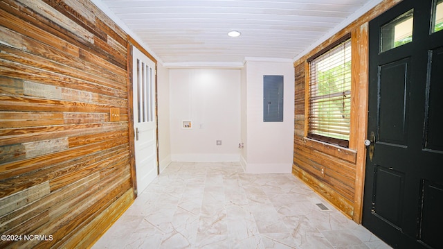 corridor with electric panel, visible vents, ornamental molding, marble finish floor, and wood walls