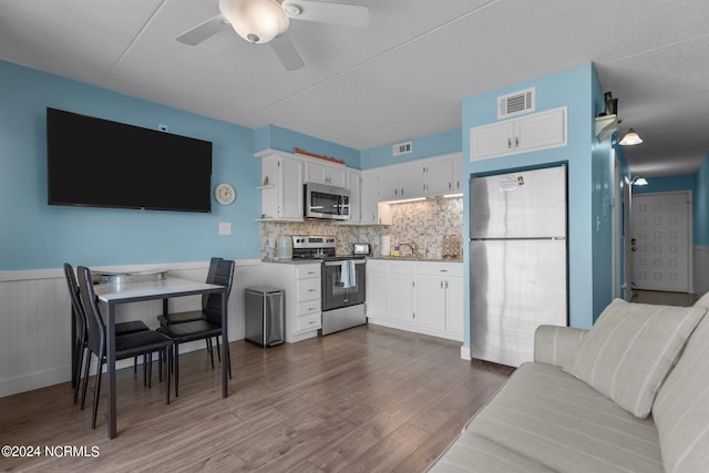 living room featuring ceiling fan and dark wood-type flooring