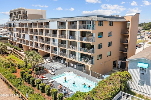 view of building exterior with a community pool