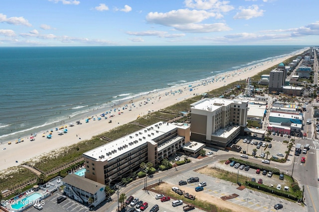 drone / aerial view with a beach view and a water view