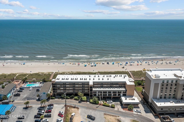 bird's eye view featuring a view of the beach and a water view