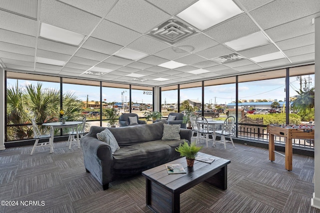 sunroom featuring a healthy amount of sunlight and a drop ceiling