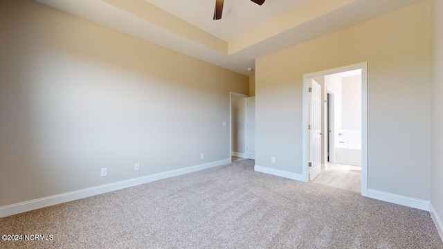 unfurnished bedroom with ceiling fan and light colored carpet