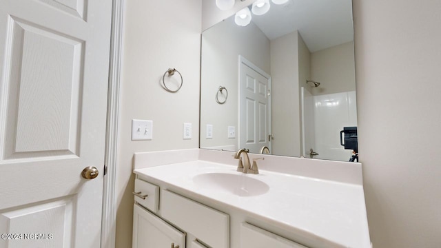 bathroom featuring vanity and a shower