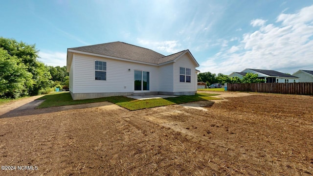 rear view of property with a patio area and a lawn