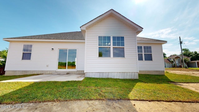 back of property featuring a lawn and a patio area