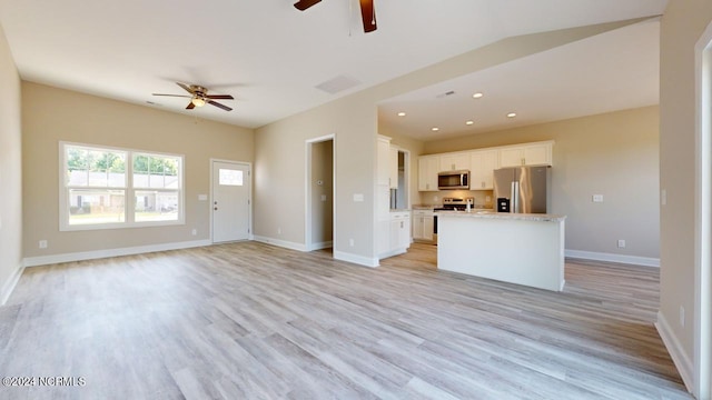 unfurnished living room featuring light hardwood / wood-style floors and ceiling fan