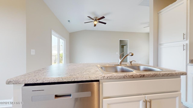 kitchen featuring white cabinets, stainless steel dishwasher, lofted ceiling, and sink