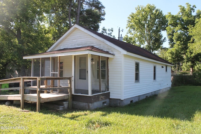 bungalow-style home featuring crawl space, a front lawn, and a wooden deck