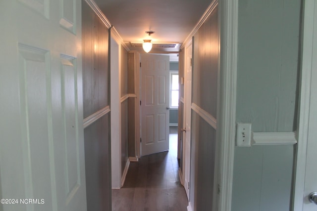 hall with dark wood finished floors and crown molding