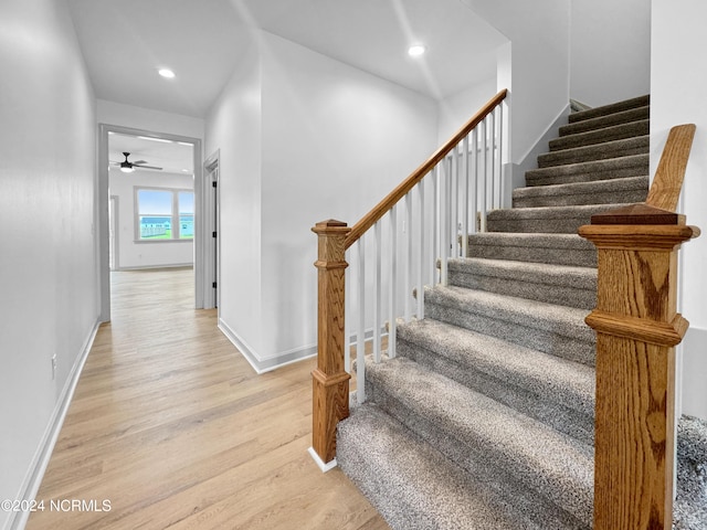 stairway with recessed lighting, ceiling fan, baseboards, and wood finished floors