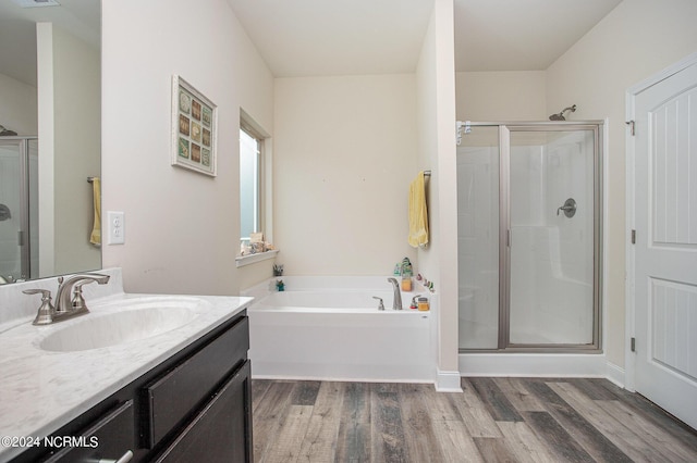 bathroom featuring visible vents, wood finished floors, vanity, a shower stall, and a bath