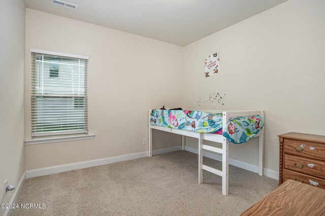 carpeted bedroom with visible vents and baseboards