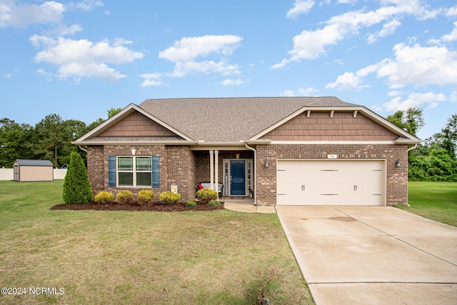 craftsman house with a garage, brick siding, concrete driveway, a storage unit, and a front yard