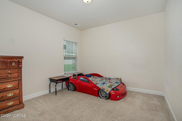 carpeted bedroom with visible vents and baseboards