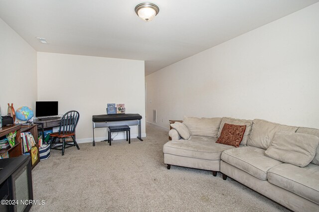 office area with light colored carpet, visible vents, and baseboards